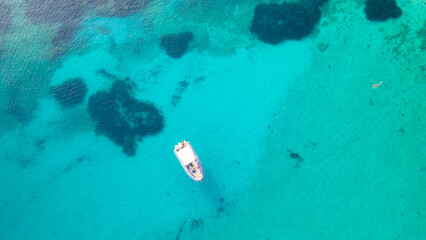 Aerial view of speedboat anchoring next to reef. Bird eye view, water sport theme. Speed boat...
