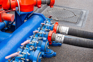 Equipment for pumping fuel. Hoses are connected to fuel machine. Petrol reloading system. Hoses for pumping fuel. Equipment for transportation and storage gasoline. Blue pipeline for pumping diesel