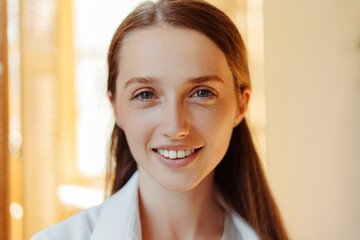 Closeup portrait of beautiful smiling woman looking at camera with toothy smile