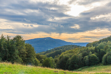 Mount Czantoria Wielka rising above the village of Ustroń seen from the Równica range in the Silesian Beskids (Poland) on a cloudy summer evening.