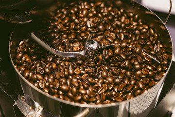 coffee beans dark oily roast aroma roasting in roastery. coffee bean roaster closeup cooling end...