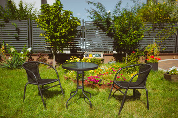 Garden furniture stands in the garden on the lawn. Place to rest