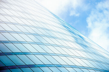 abstract background of a glazed skyscraper and the reflection of clouds in it