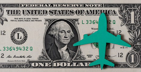 The symbolic figure of an airplane on a bill of denomination of 1 US dollar - obrazy, fototapety, plakaty