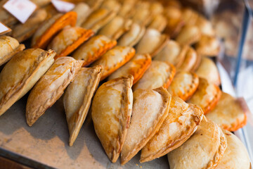 Freshly baked empanadas with different fillings for sale