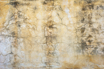 Cracked rough old dirty plastered wall abstract background