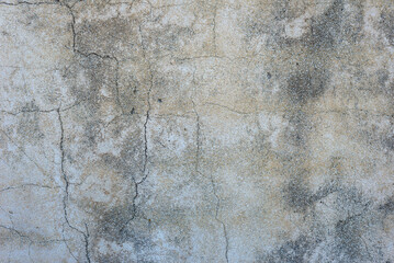 Cracked damaged rough old grey dirty plastered wall abstract background