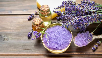 Wandaufkleber Aromatherapy oil and lavender, lavender spa, Wellness with lavender, lavender syrup on a wooden background © Uuganbayar