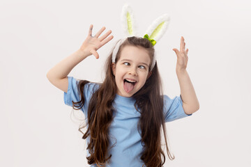 Cute little child girl with bunny ears on white background. Funny face