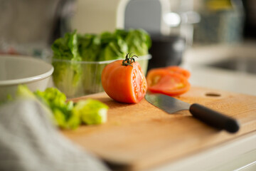 cutting board with vegetables and knife on counter