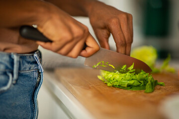Close up hands cutting vegetables with knife