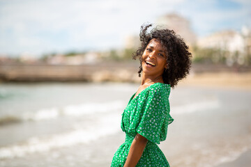 happy young african american woman by beach