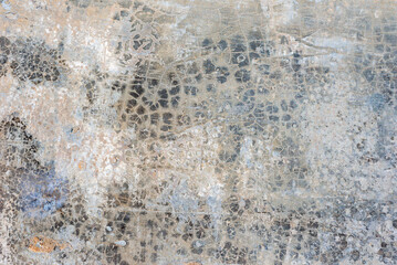 Chaotically cracked old concrete wall surface texture background.