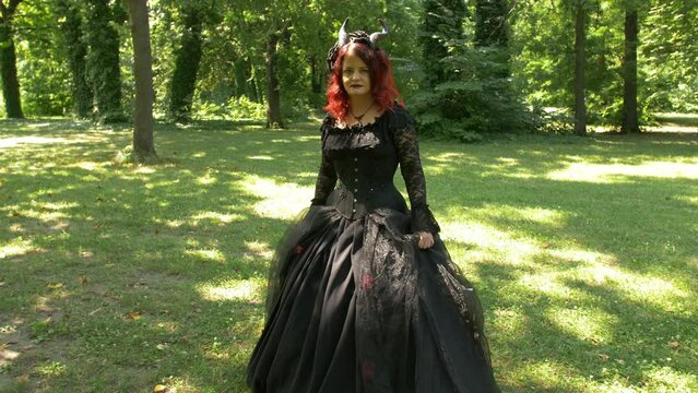 Succubus cosplay girl in the forest moving toward you, Full Shot Slow Motion.