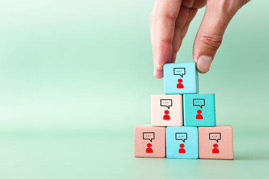 Wooden cubes with figures icons speech bubbles. Concept of communication, information, and cooperation