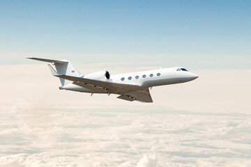 Fototapeta na wymiar White luxury private jet flying in the air above the clouds