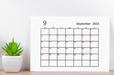 The September 2023 monthly calendar for 2023 on wooden background.