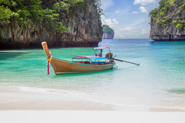 Fototapeta na wymiar The Thai traditional wooden longtail boat and beautiful beach in Phuket province, Thailand.
