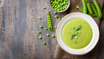 green peas soup on rustic background, top view, copy space