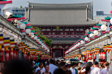 Tourists and locals crowd into Nakamise Dori Street and the Sensoji temple in Tokyo, Japan