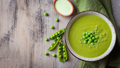 green peas soup on rustic background, top view, copy space
