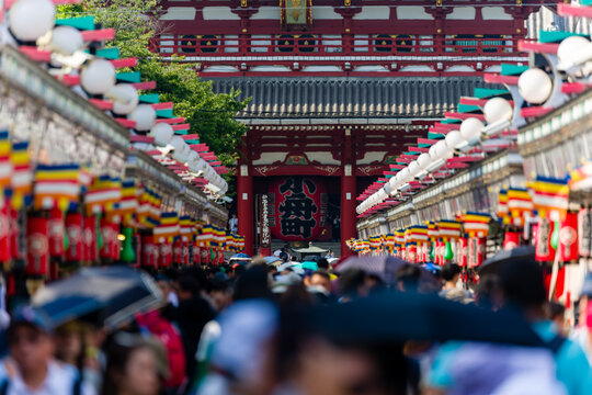 Tourists and locals crowd into Nakamise Dori Street and the Sensoji temple in Tokyo, Japan