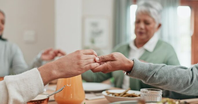 Family, people and holding hands for praying on food at dinner table at home. Closeup of group in worship, prayer or thanks for eating lunch meal, respect or gratitude in dining room at thanksgiving