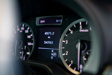 Close-up of the odometer and dashboard of a luxury car with a black interior after detailing and...