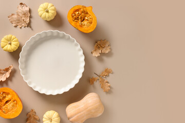 Autumn concept cook Pumpkin pie and ingredients on beige background. Top view. Thanksgiving Day.