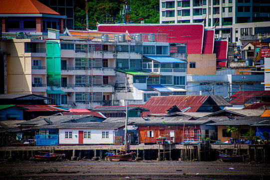 A fishing village by the sea behind buildings and shop houses in Si Racha district, Thailand