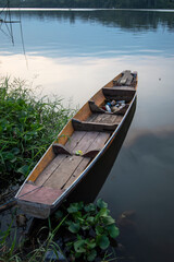 Fishing wooden boat on the river bank