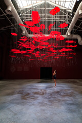 Girl looking at the work craft hanging in the empty hall during Venice Biennale 2023