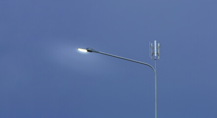 Small wind turbine on street light pole with blue sky background, Lamp post with solar and wind turbine alternative energy for better world concept