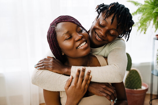 Black lesbian couple hugging while spending time together