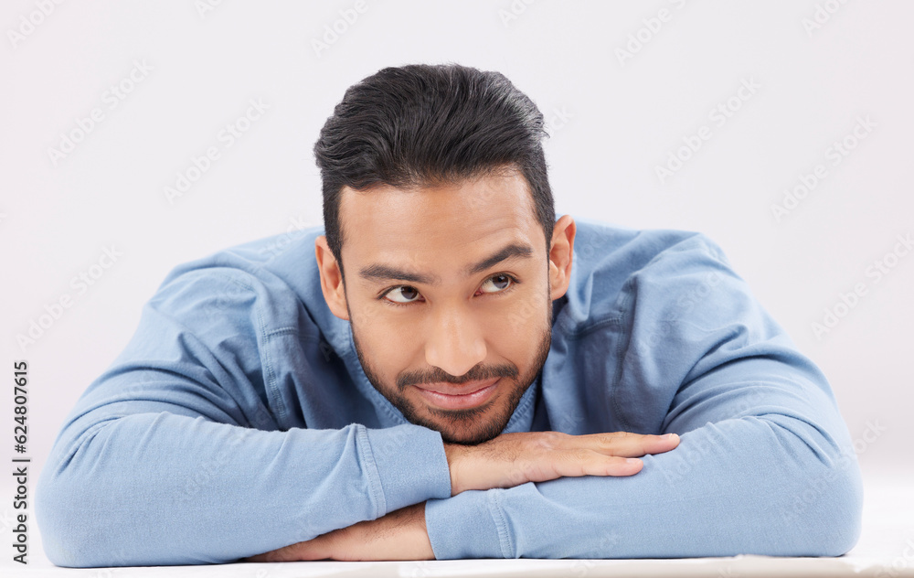 Aufkleber thinking, dreaming and young man in a studio resting on his arms with a contemplating facial express