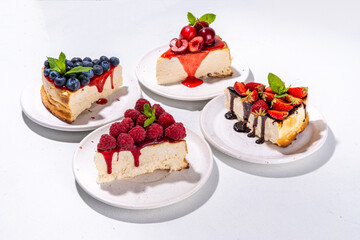 

Summer cafe baking menu background, sweet cheesecake portion slices with various toppings, jam and berry fruits - strawberry, blueberry, raspberry, cherry 