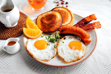 breakfast pancakes fried eggs and sausages