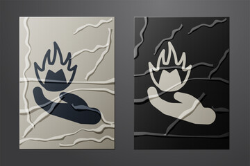 White Hand holding a fire icon isolated on crumpled paper background. Paper art style. Vector