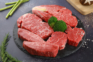 Raw beef on a black plate