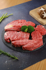 Raw beef on a black plate