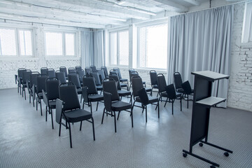 Clear conference room, classroom. White brick wall.