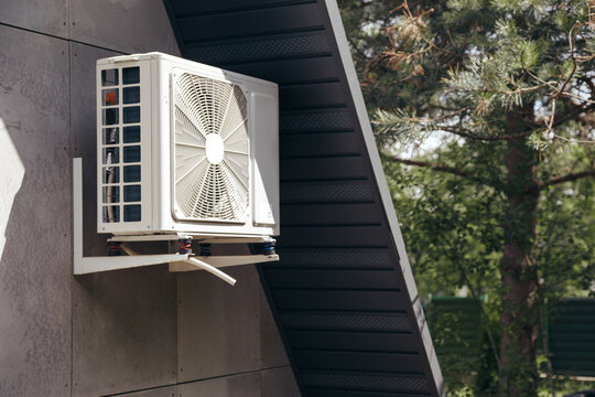 External Unit Of An Air Conditioner On Facade Of Small Wooden Forest House