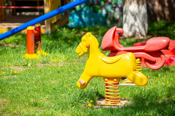 Bright playground in the park. Playground with slides and swings for children.