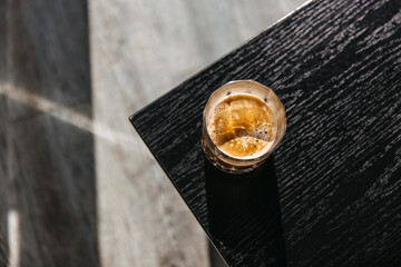 Naklejka premium Cup of coffee on a wooden table, top view.