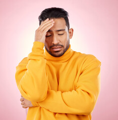 Stress, headache and asian man in studio with depression, broken heart or brain fog on pink...