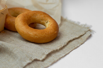 Small dry bagels, small buns on a light background. Bakery.