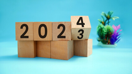 From 2023 to 2024. Flipping of 2023 to 2024 on wooden cubes for preparation of new year change and...