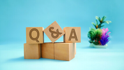 Q and A - Q and A abbreviations on wooden block surface with engraved effect of letters Q and A....
