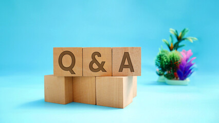Q and A - Q and A abbreviations on wooden block surface with engraved effect of letters Q and A....