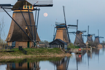 Windmills of Kinderdijk Alblasserdam UNESCO site under a rising full moon